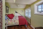 Second floor guest room with a queen bed.